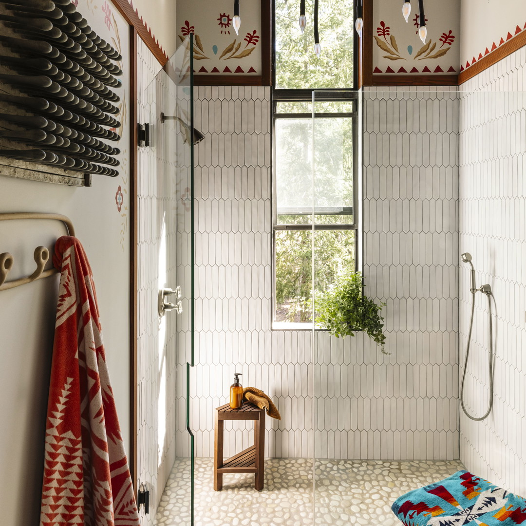 a bath room with a toilet a sink and a window