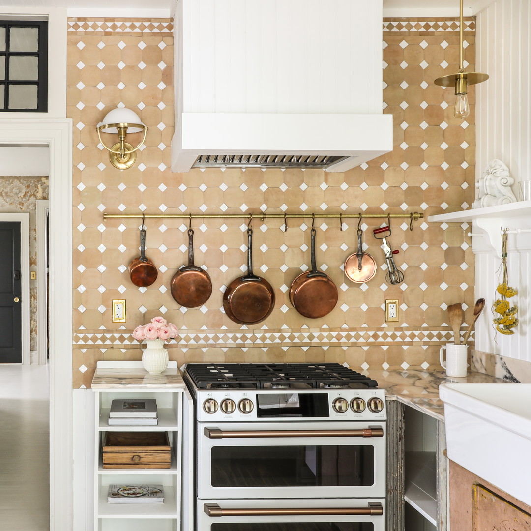 a kitchen with pots and pans hanging on the wall