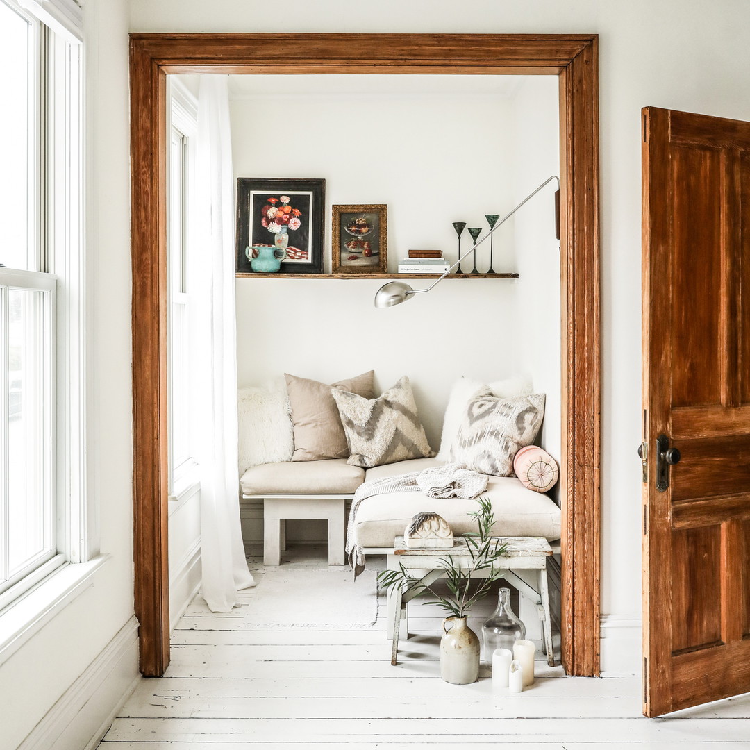 a living room with a white couch and a wooden door