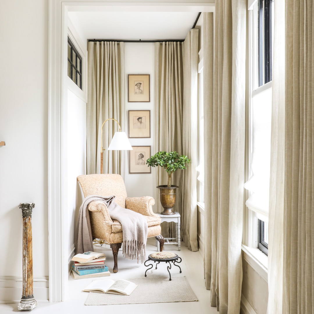 a living room filled with furniture and a lamp