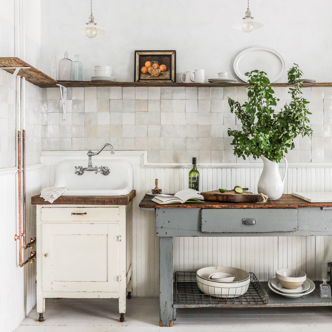 a kitchen with a sink and a table with dishes on it