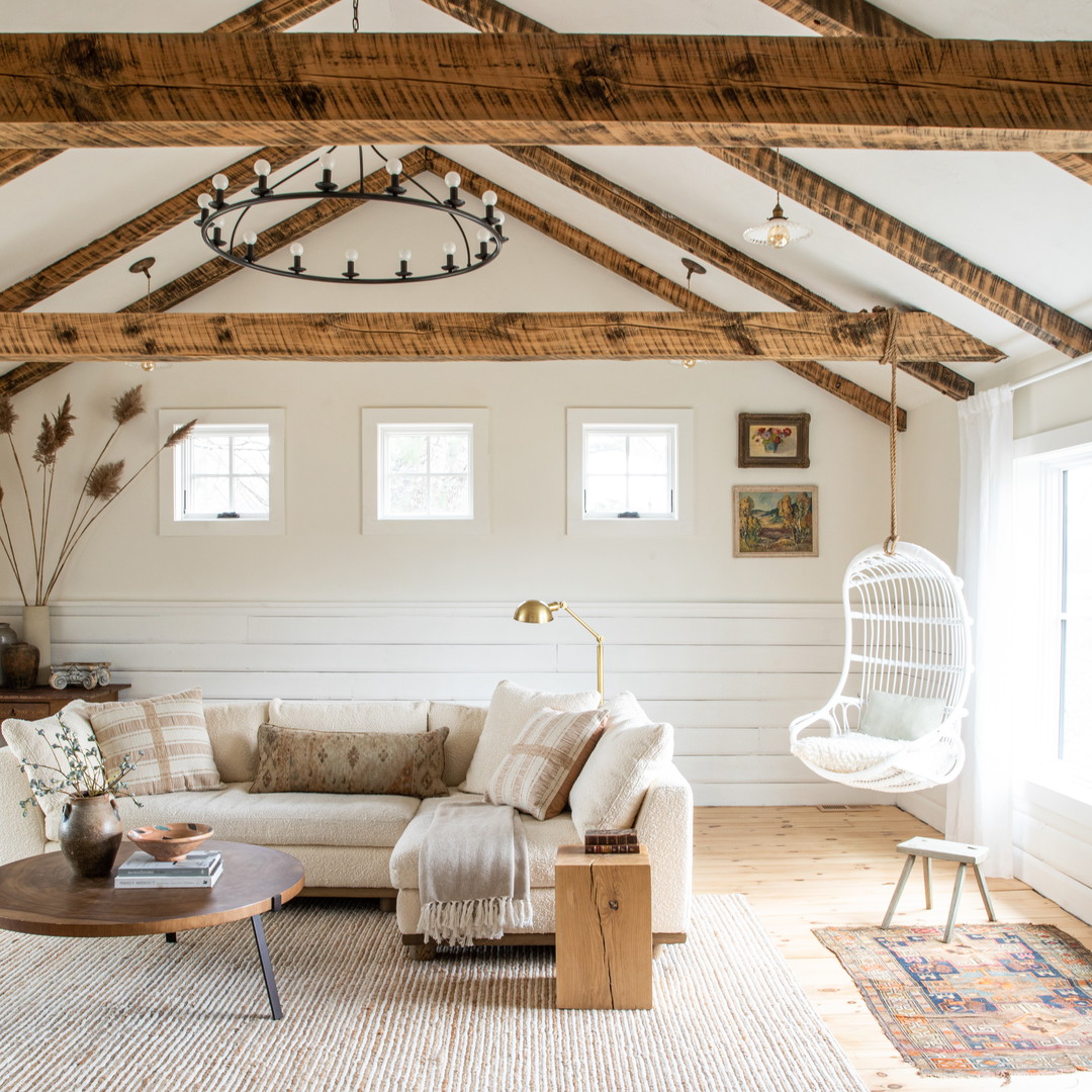 a living room filled with furniture and a wooden ceiling