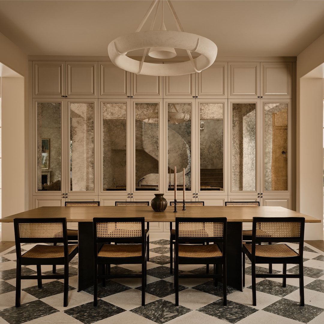 a dining room with a checkered floor and a chandelier