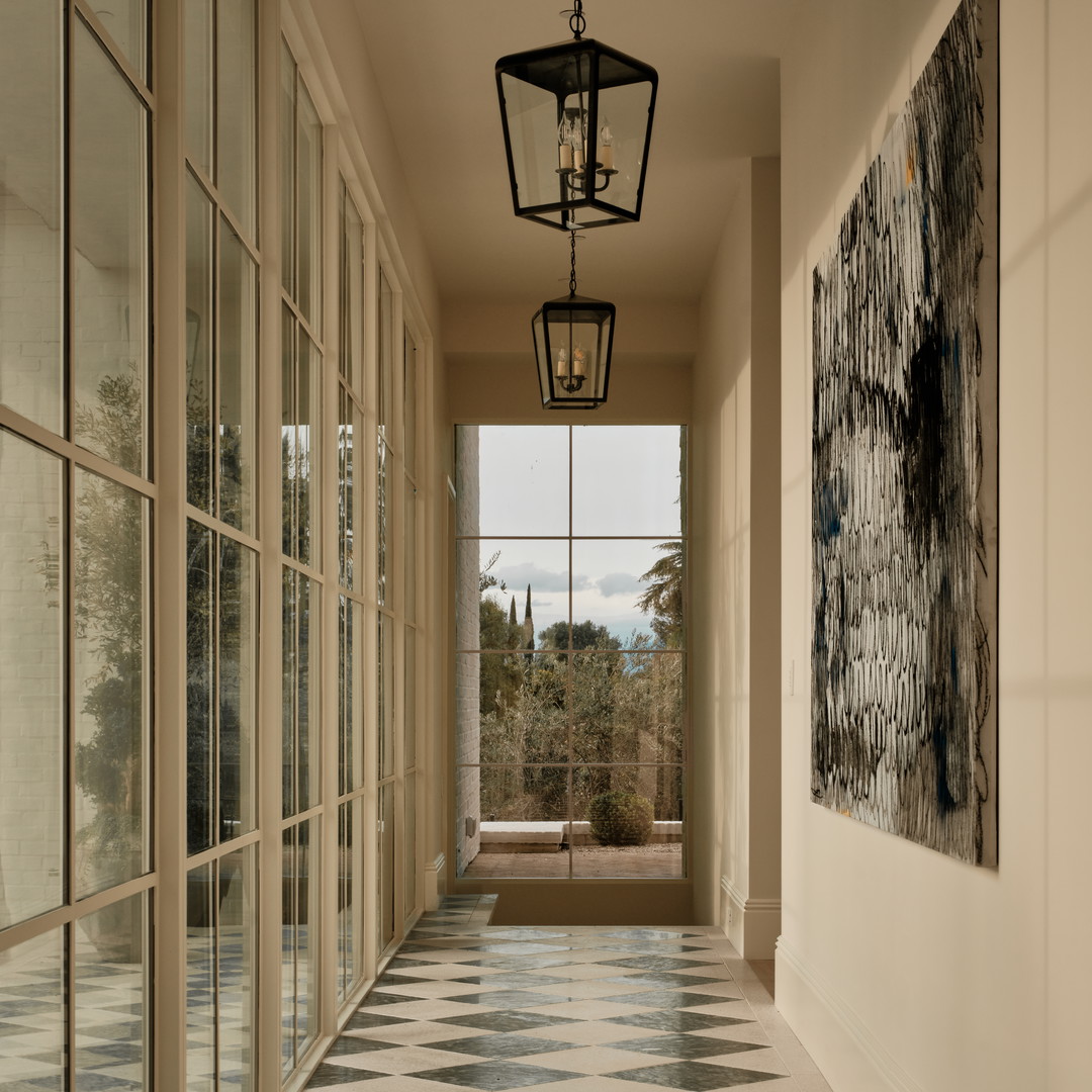 a hallway with a checkered floor and a lantern hanging from the ceiling