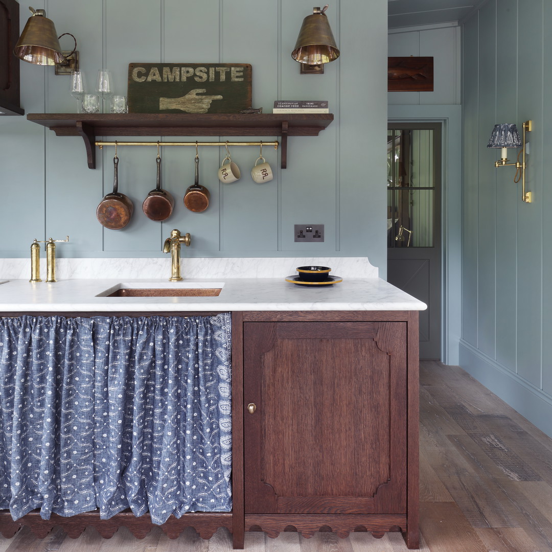 a kitchen with blue walls and wooden cabinets