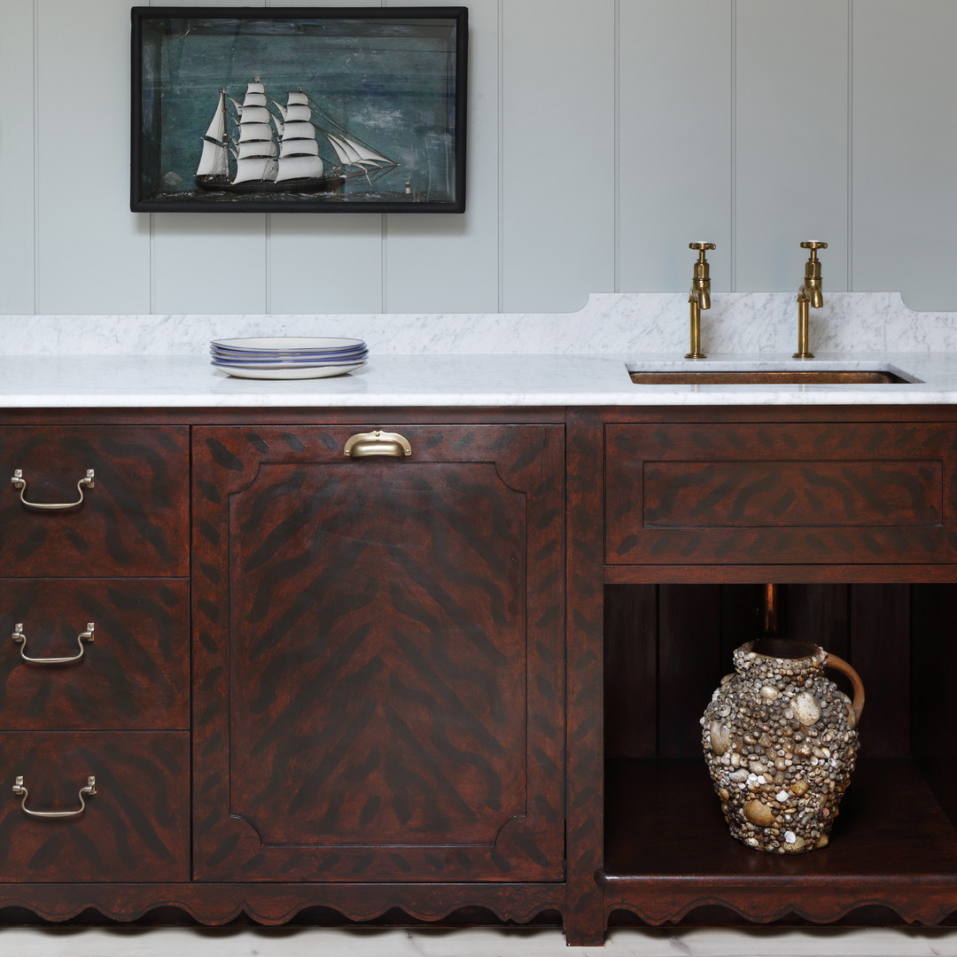 a bathroom with a sink and a painting on the wall