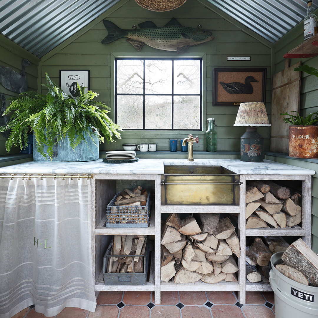 a kitchen with a stove top oven and lots of wood