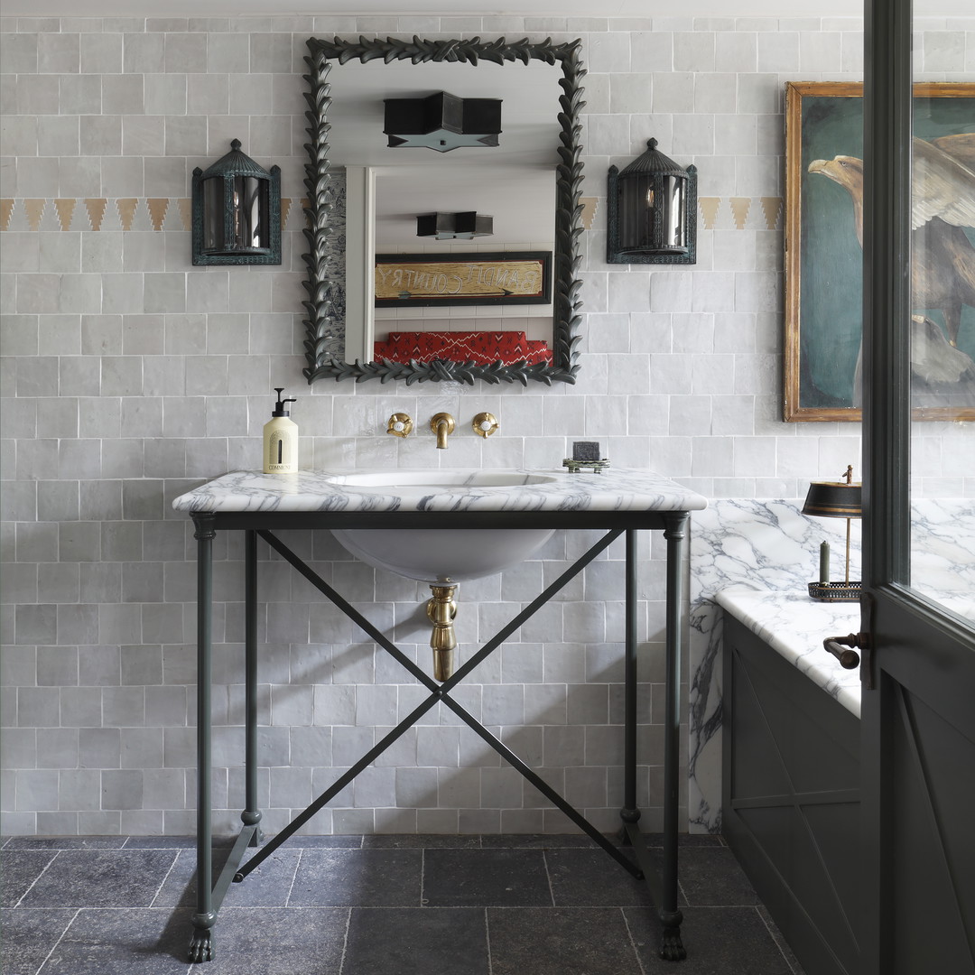 a bathroom with a marble counter top and a mirror