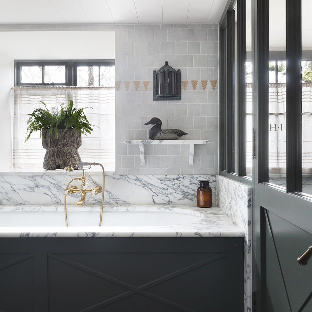 a kitchen with a marble counter top and black cabinets