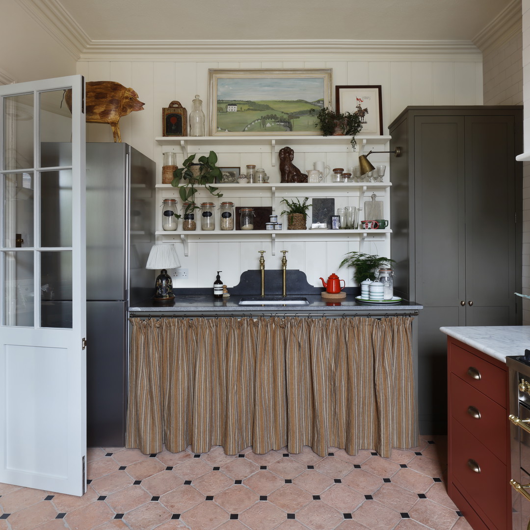 a kitchen with a stove top oven next to a doorway