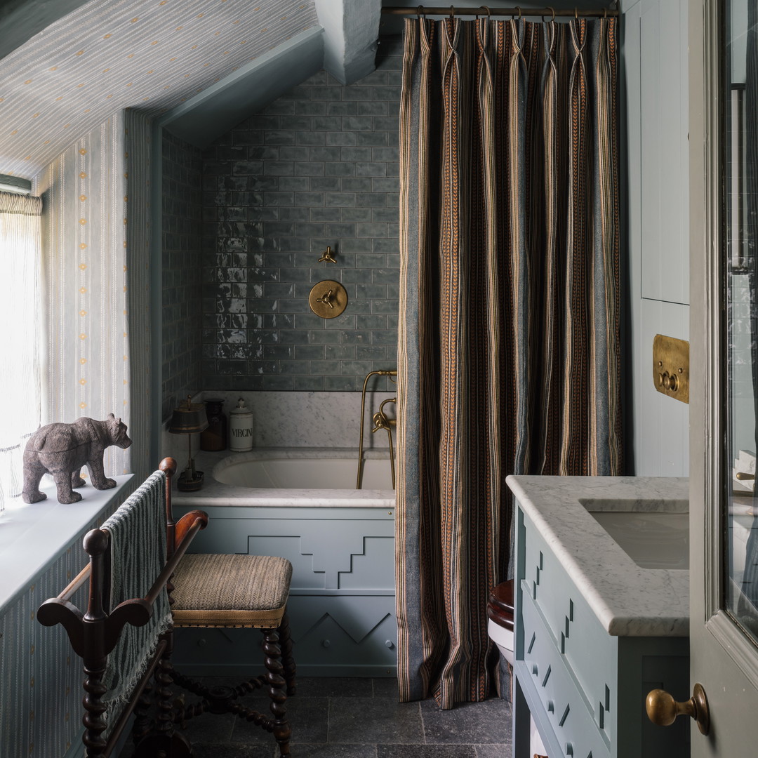 a bathroom with a tub, sink, and window