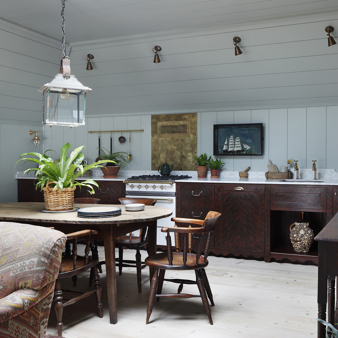 a living room with a couch a table and a potted plant