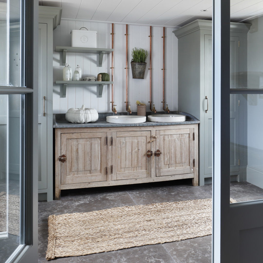 a bathroom with two sinks and a rug on the floor