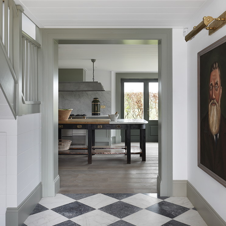 a hallway with a checkered floor and a painting on the wall