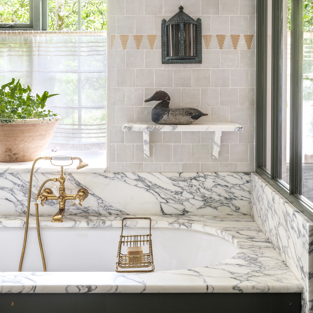 a bathroom with a tub and a sink