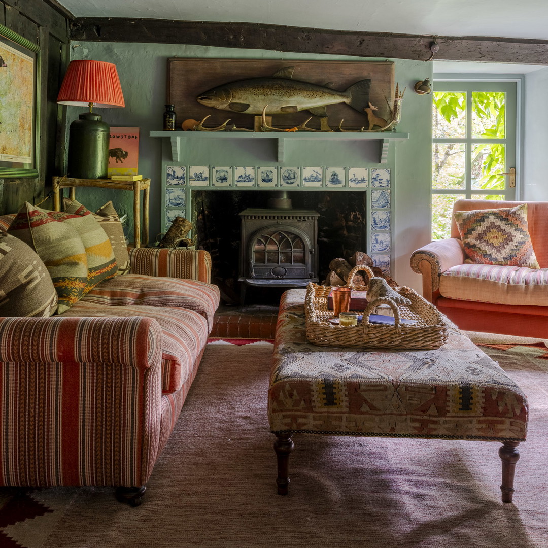 a living room filled with furniture and a fire place