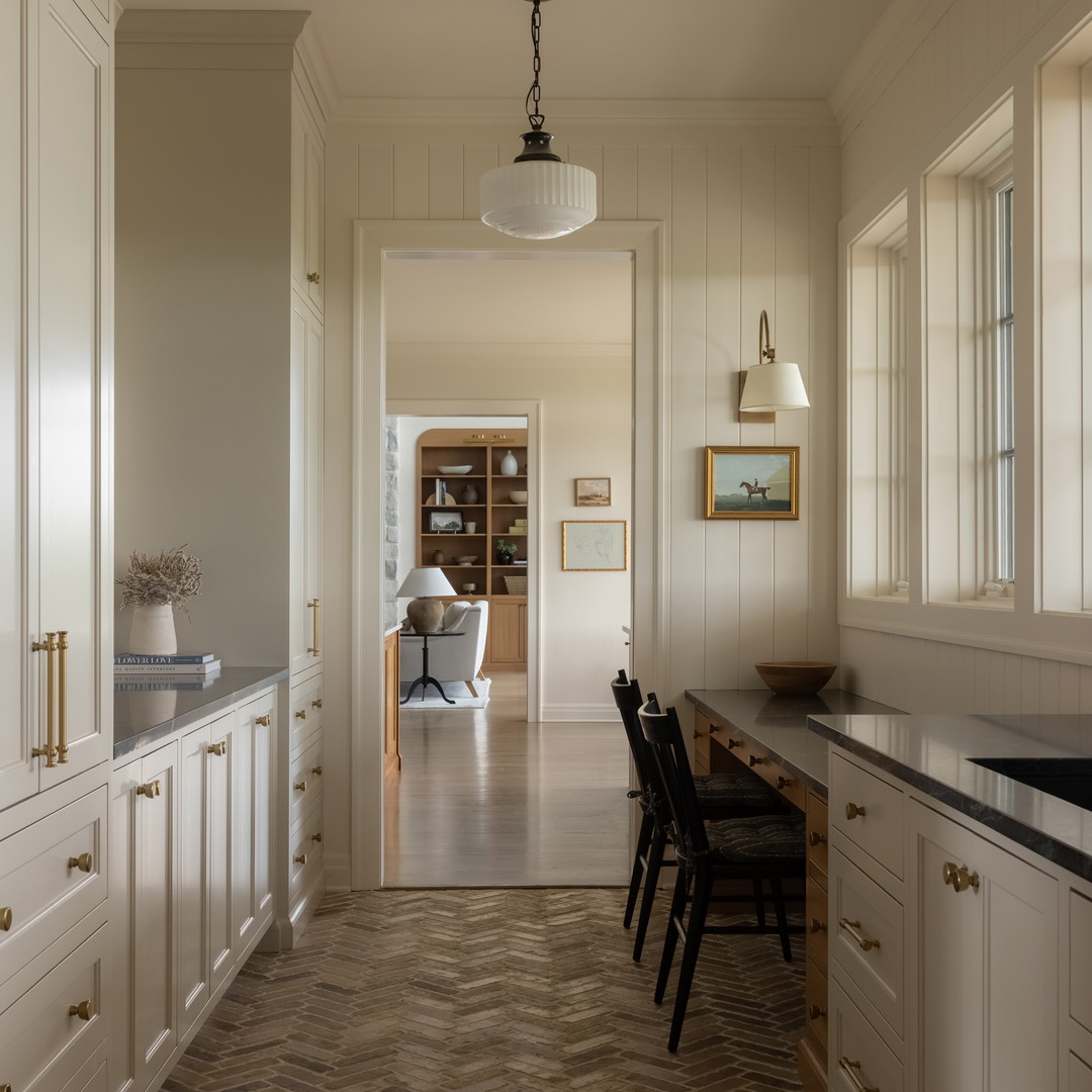 a kitchen with white cabinets and a wood floor