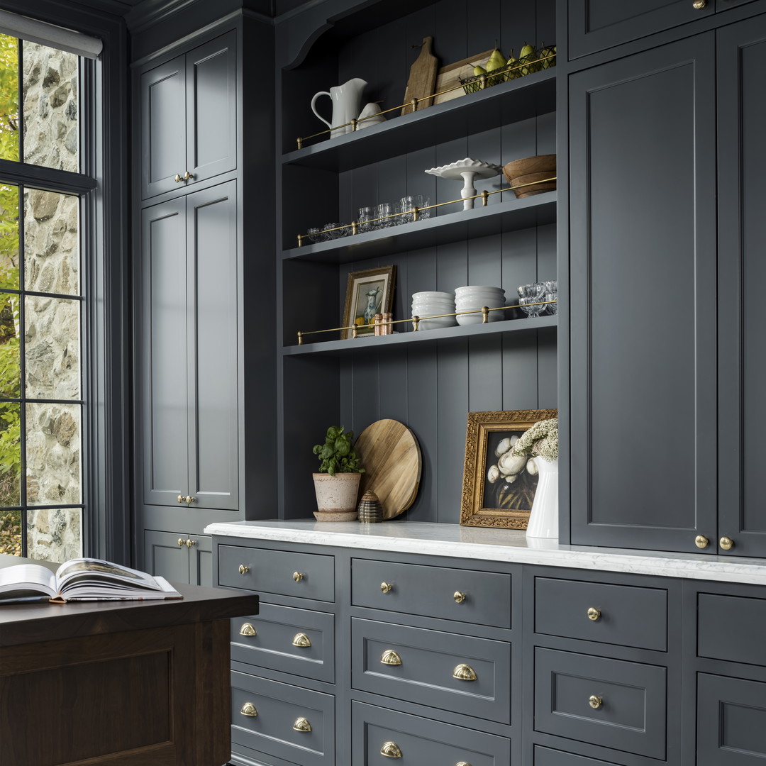a kitchen with gray cabinets and a checkered floor
