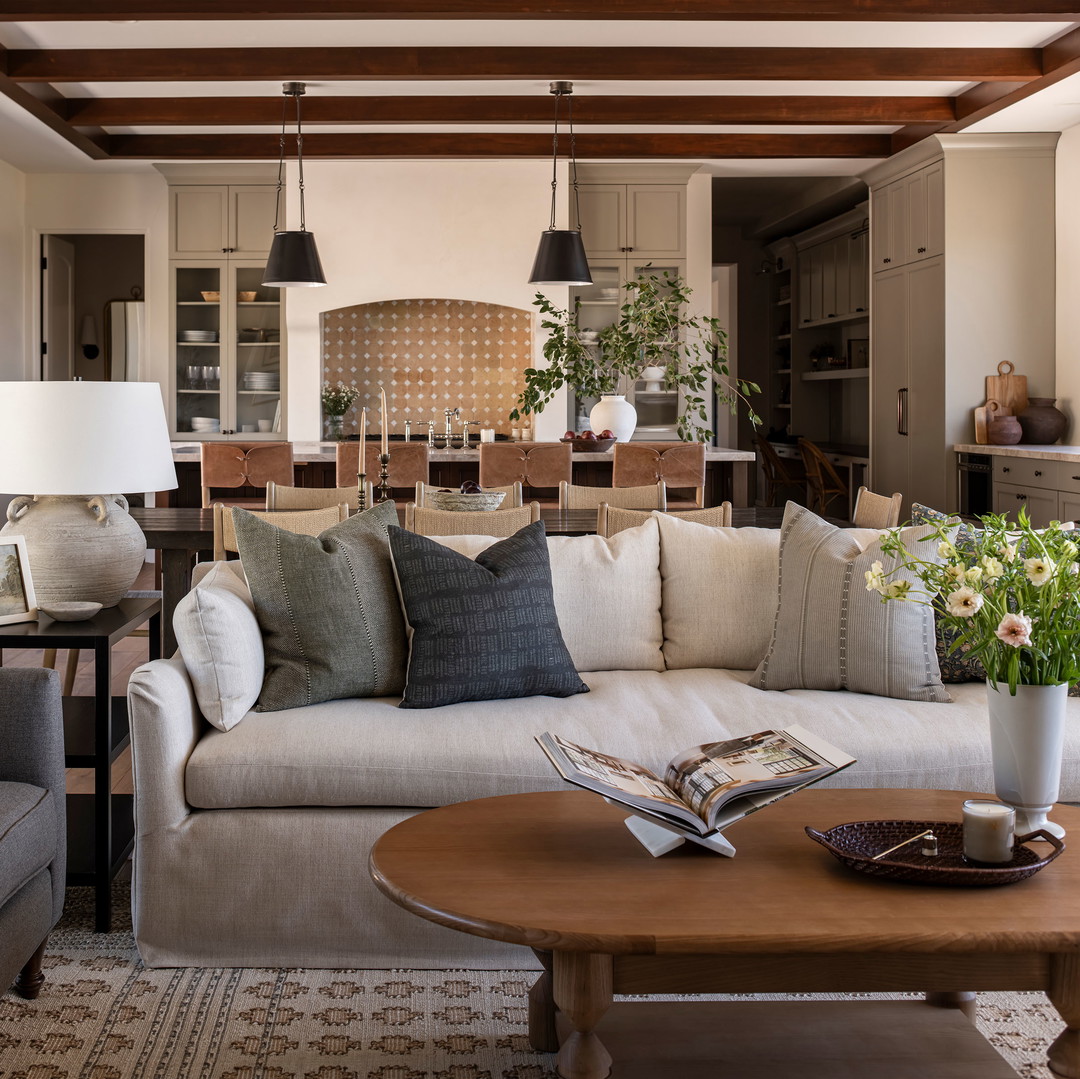 a living room filled with furniture and lots of windows