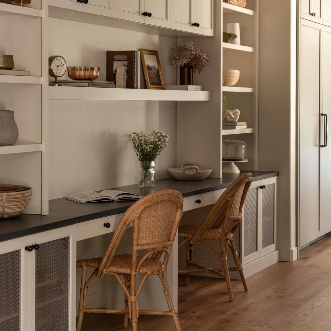 a kitchen with white cabinets and a black counter top