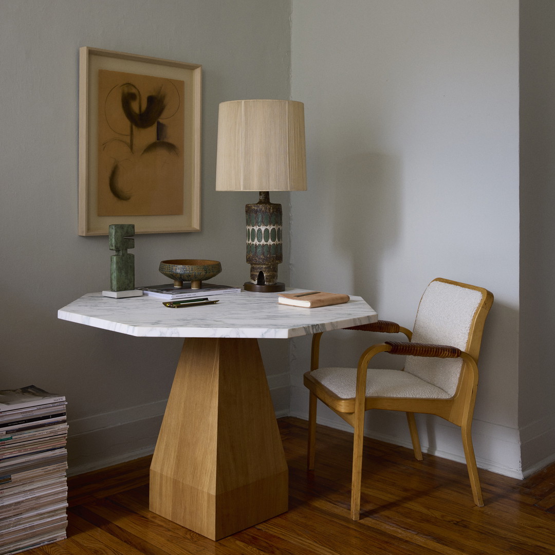 a table with a lamp and a chair in a room