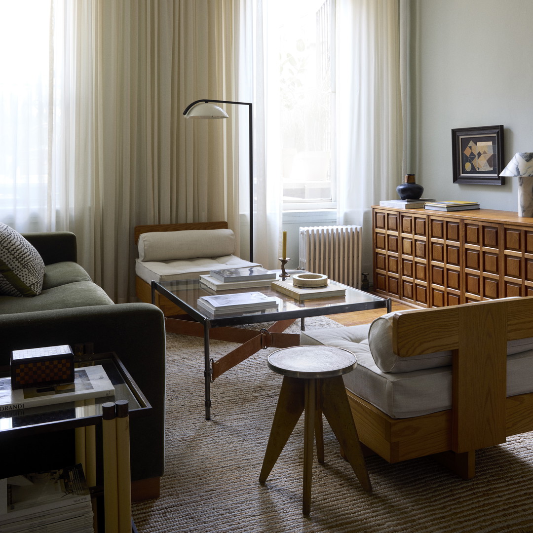 a living room filled with furniture and a large window