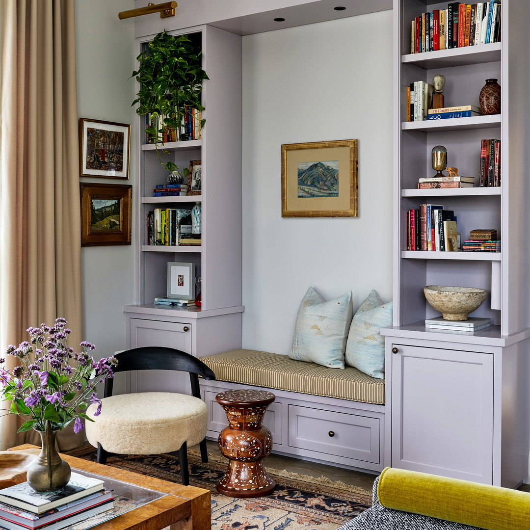 a living room filled with furniture and a book shelf