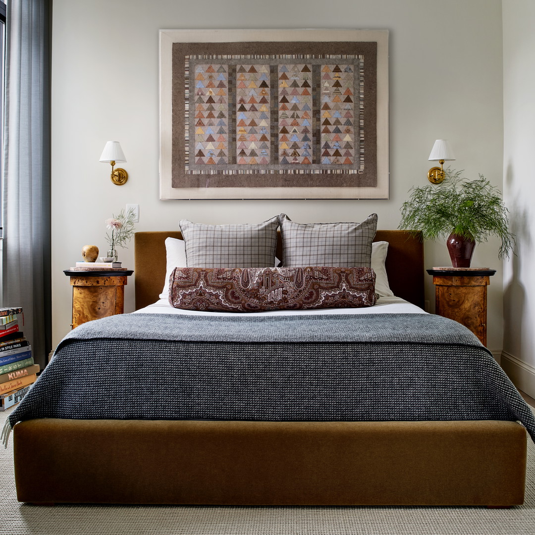 a bedroom with a large bed and a painting on the wall