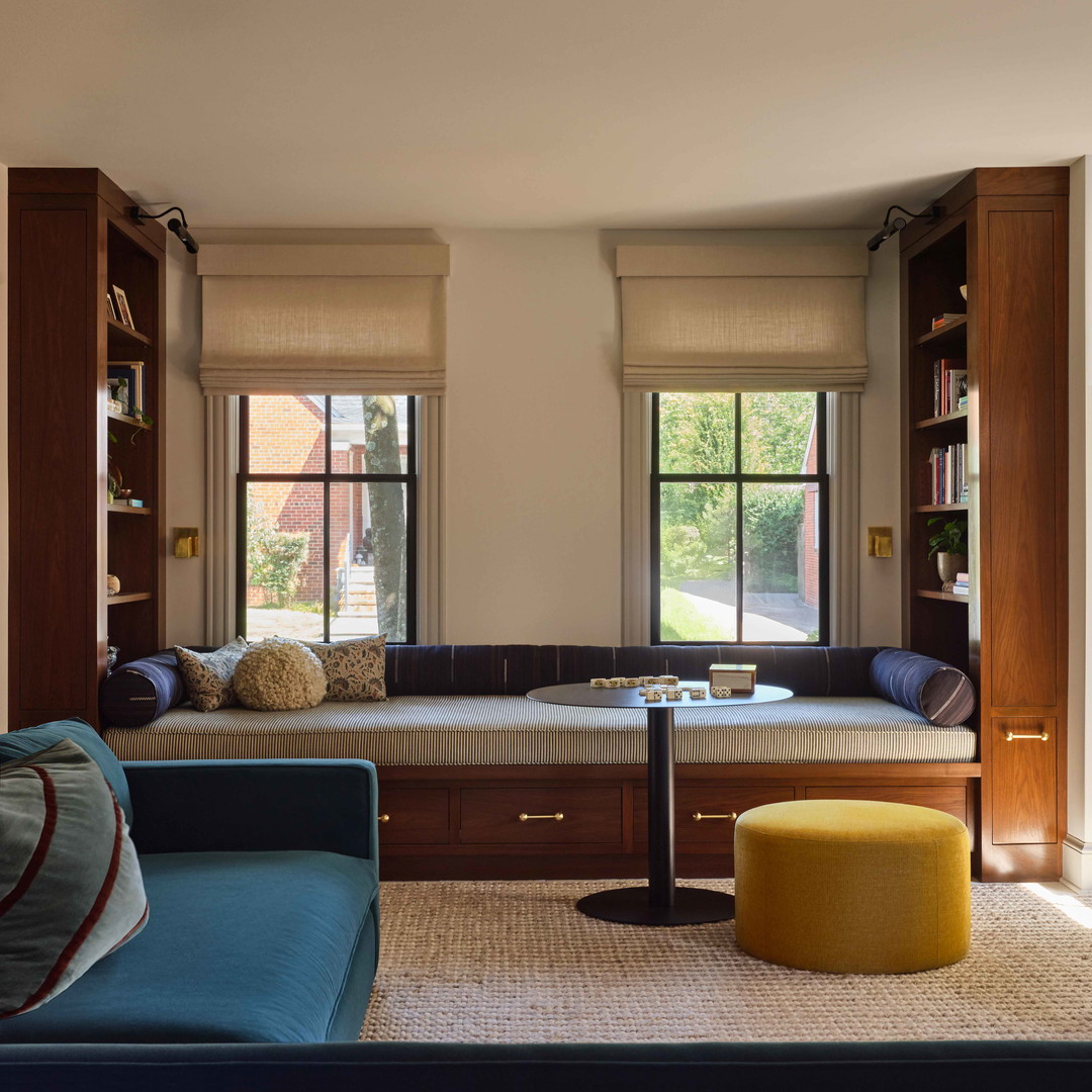 a living room filled with furniture and a window