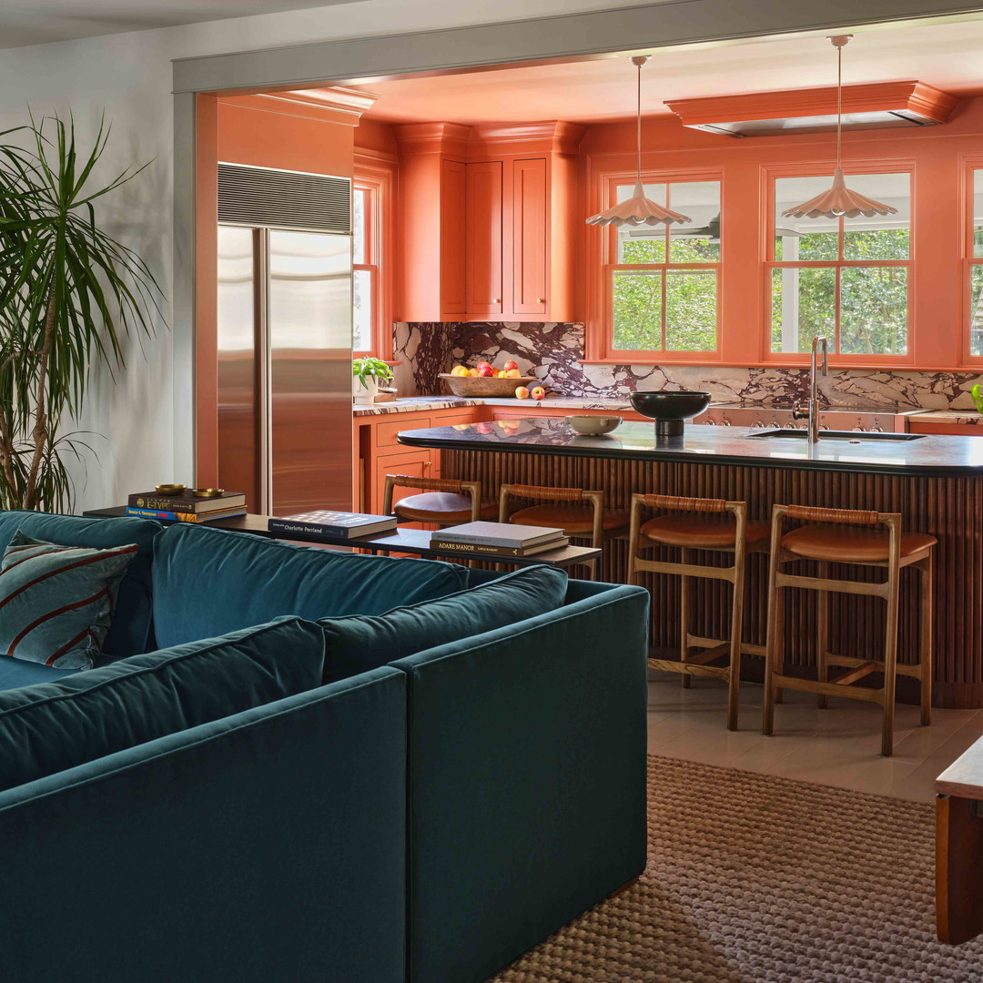 a living room filled with furniture and a kitchen