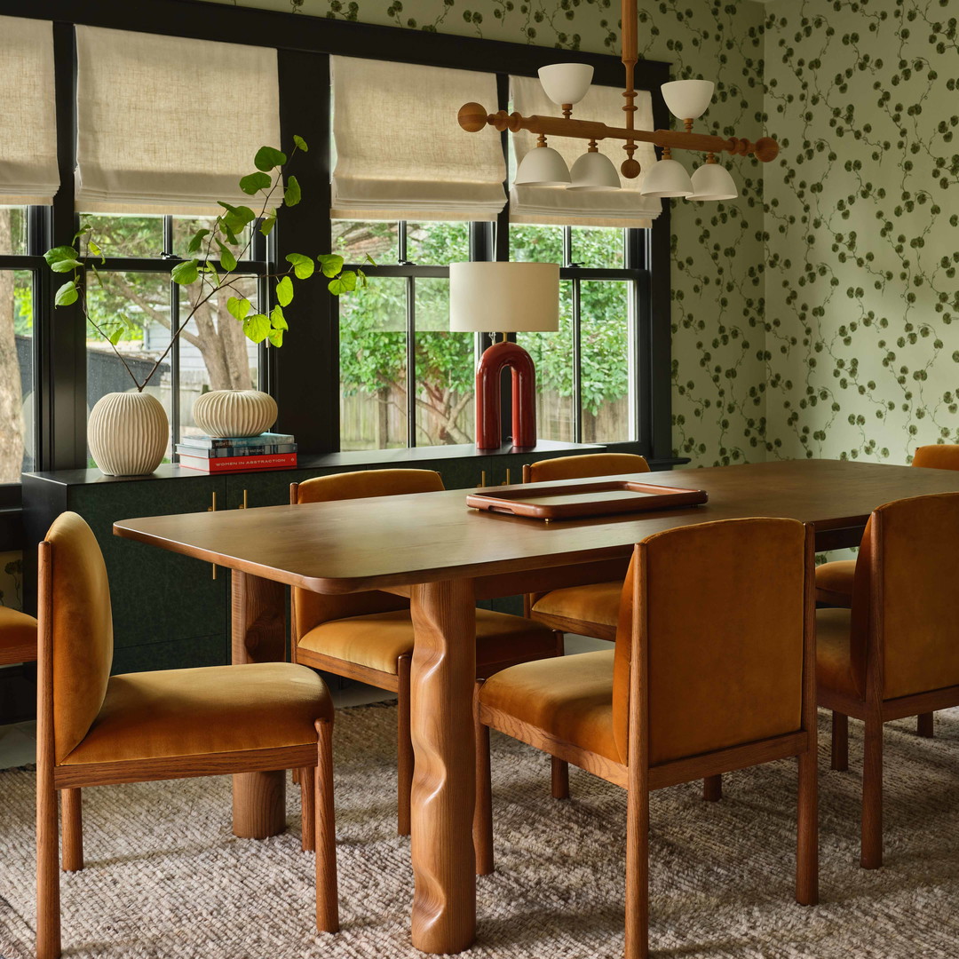 a dining room with a table and chairs