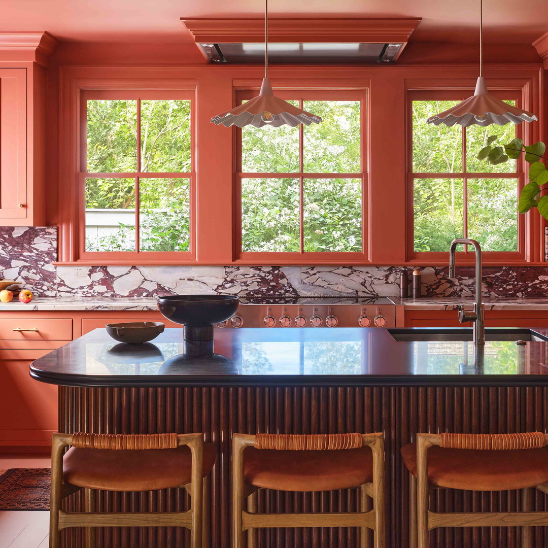 a kitchen with orange cabinets and a center island