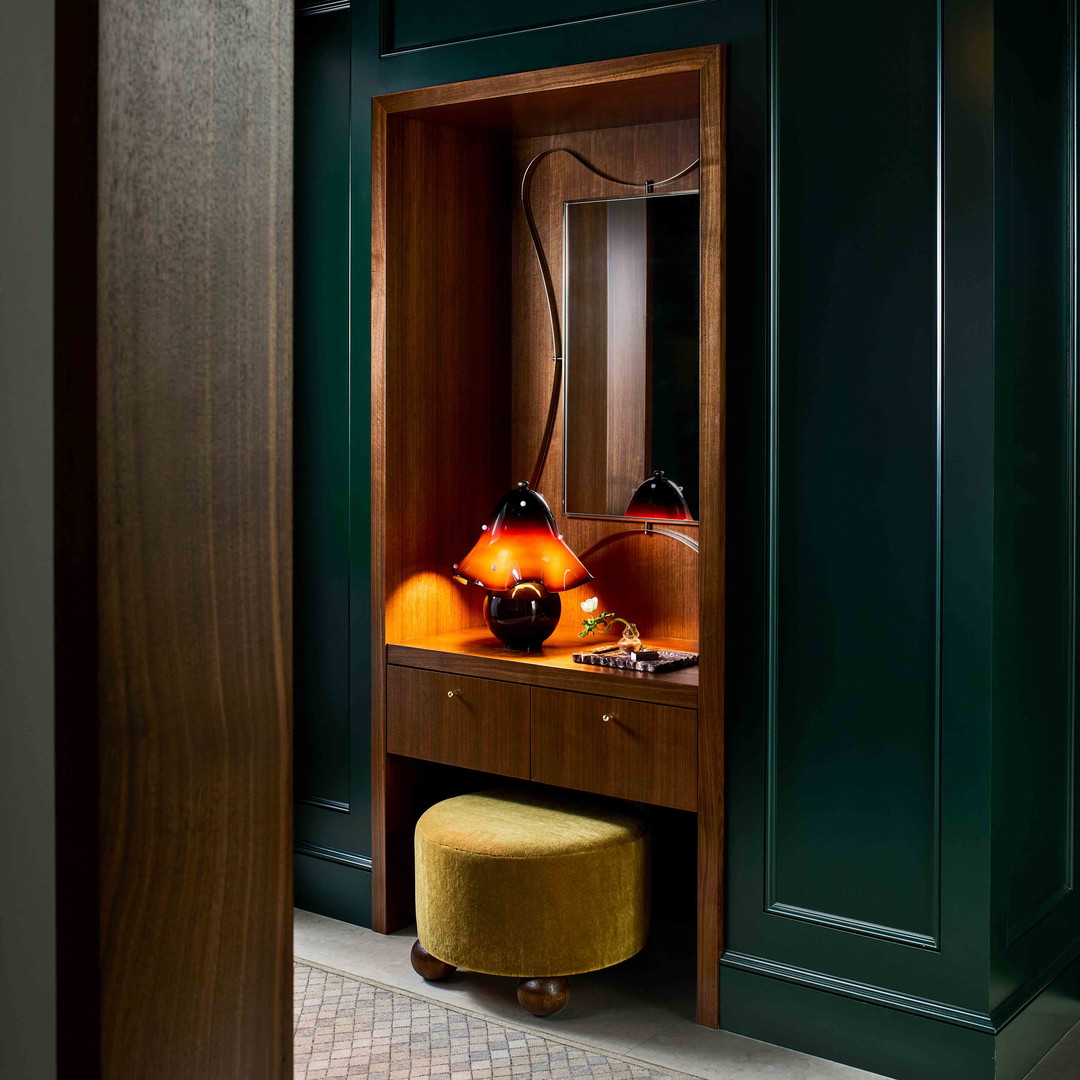 a room with green walls and a wooden cabinet