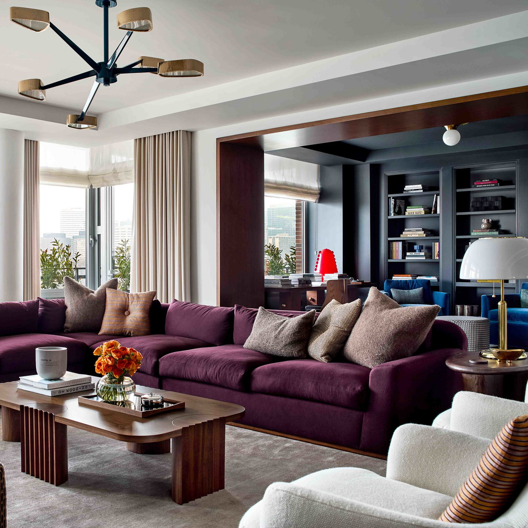 a living room filled with furniture and a large window