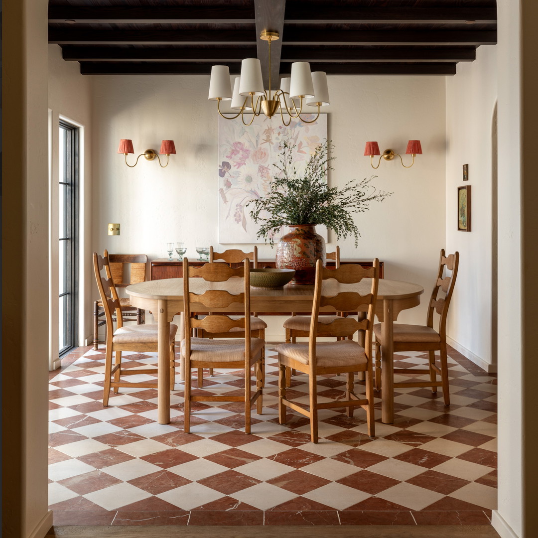 a dining room with a table and chairs