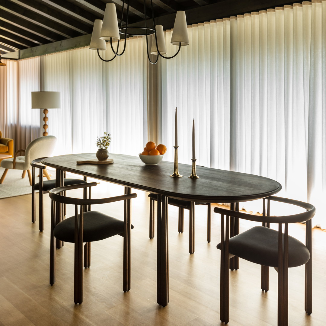 a dining room with a table and chairs