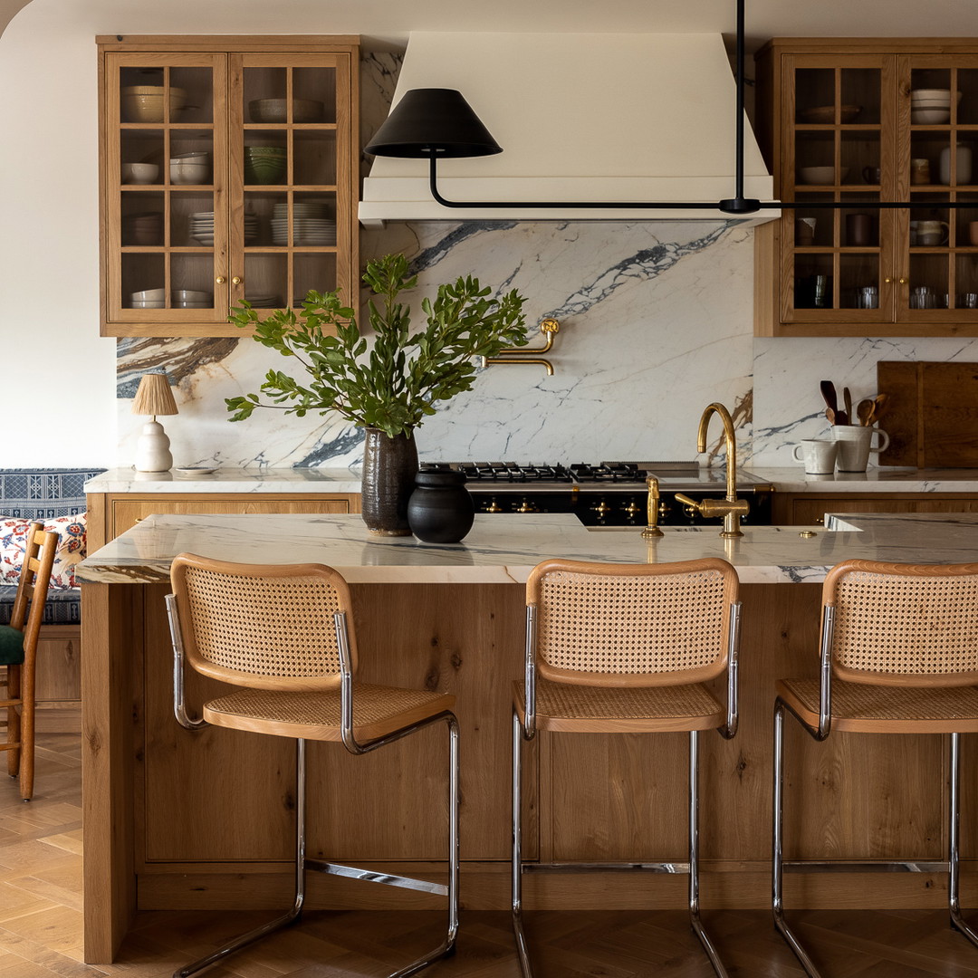 a kitchen with a marble counter top and wooden cabinets