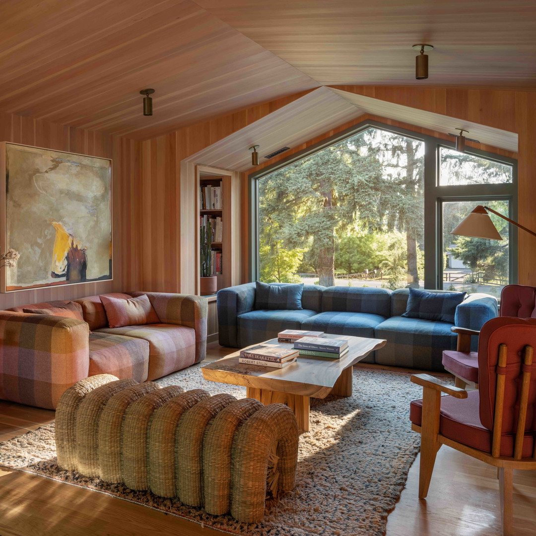 a living room filled with furniture and a large window