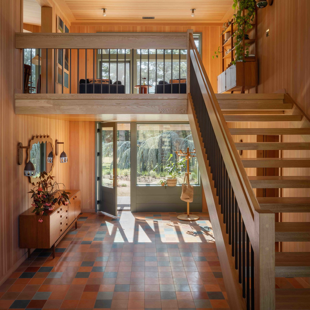 a large open floor plan with a staircase leading to a second story