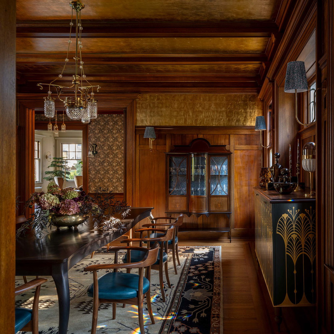 a dining room with a table, chairs and a chandelier