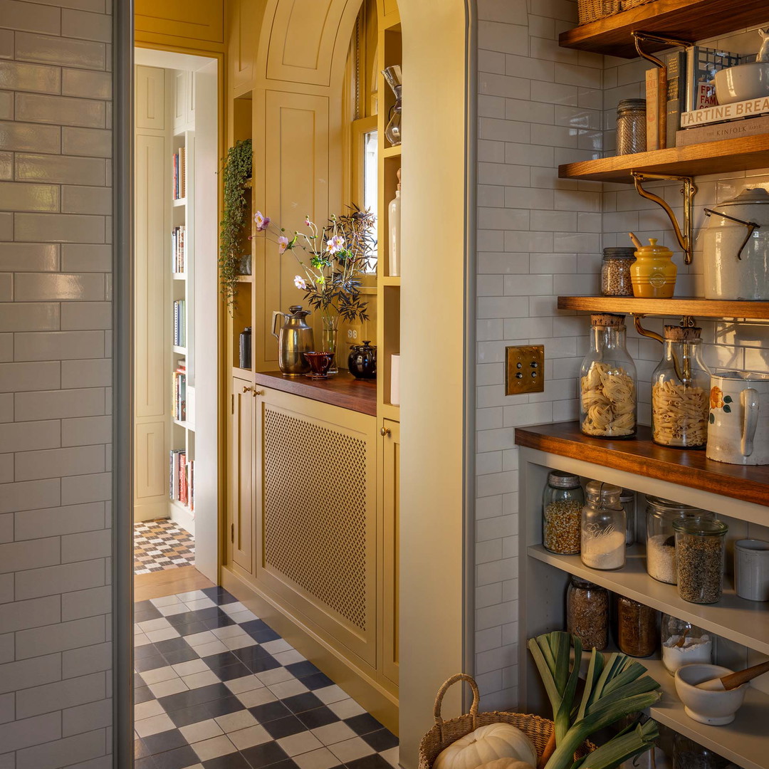 a kitchen with a checkerboard floor and yellow walls