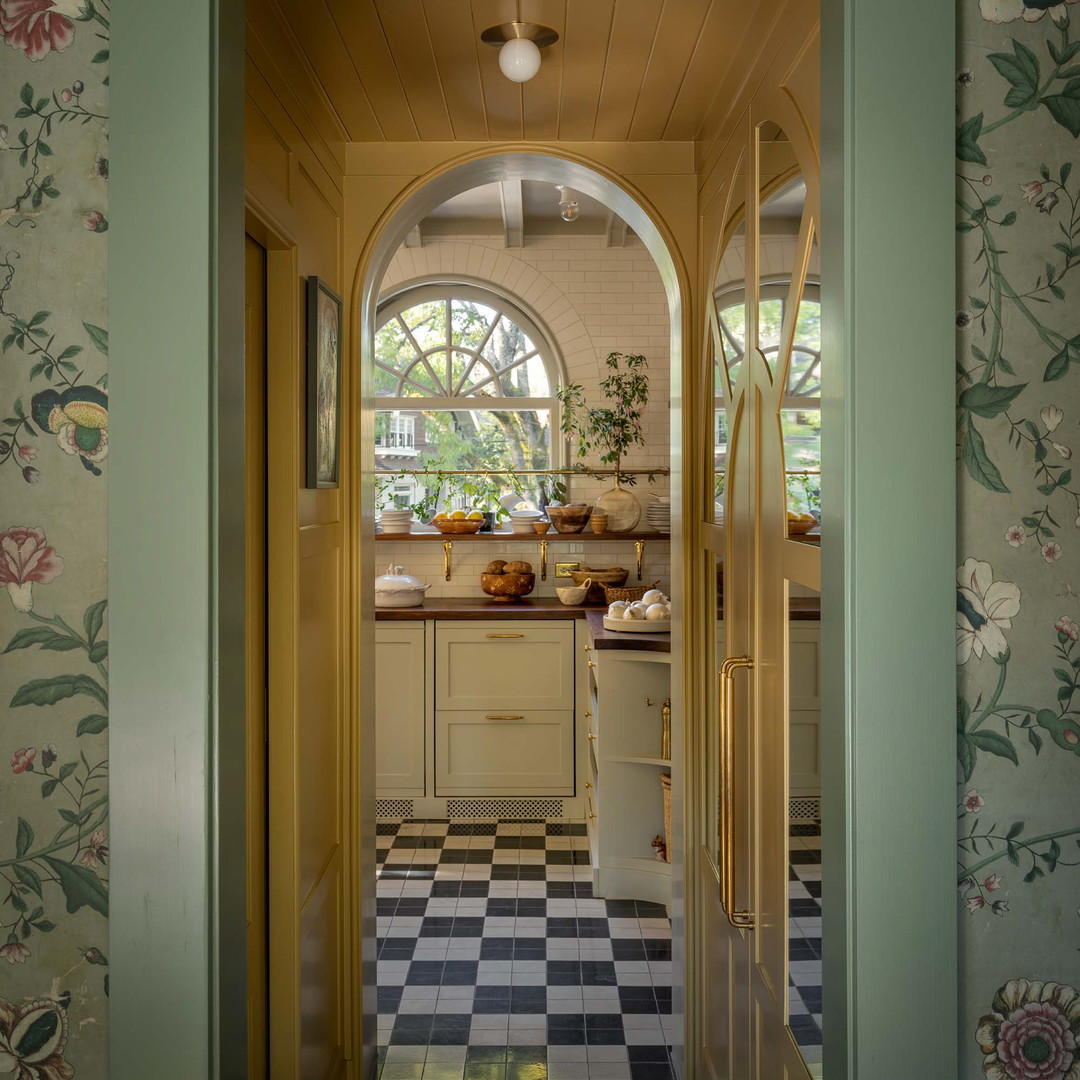 a kitchen with a checkered floor and yellow door