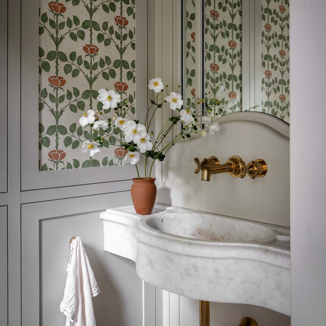 a white sink sitting under a mirror in a bathroom