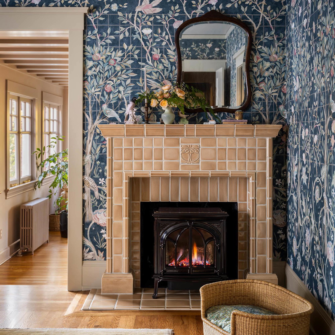 a living room with a fireplace and a mirror