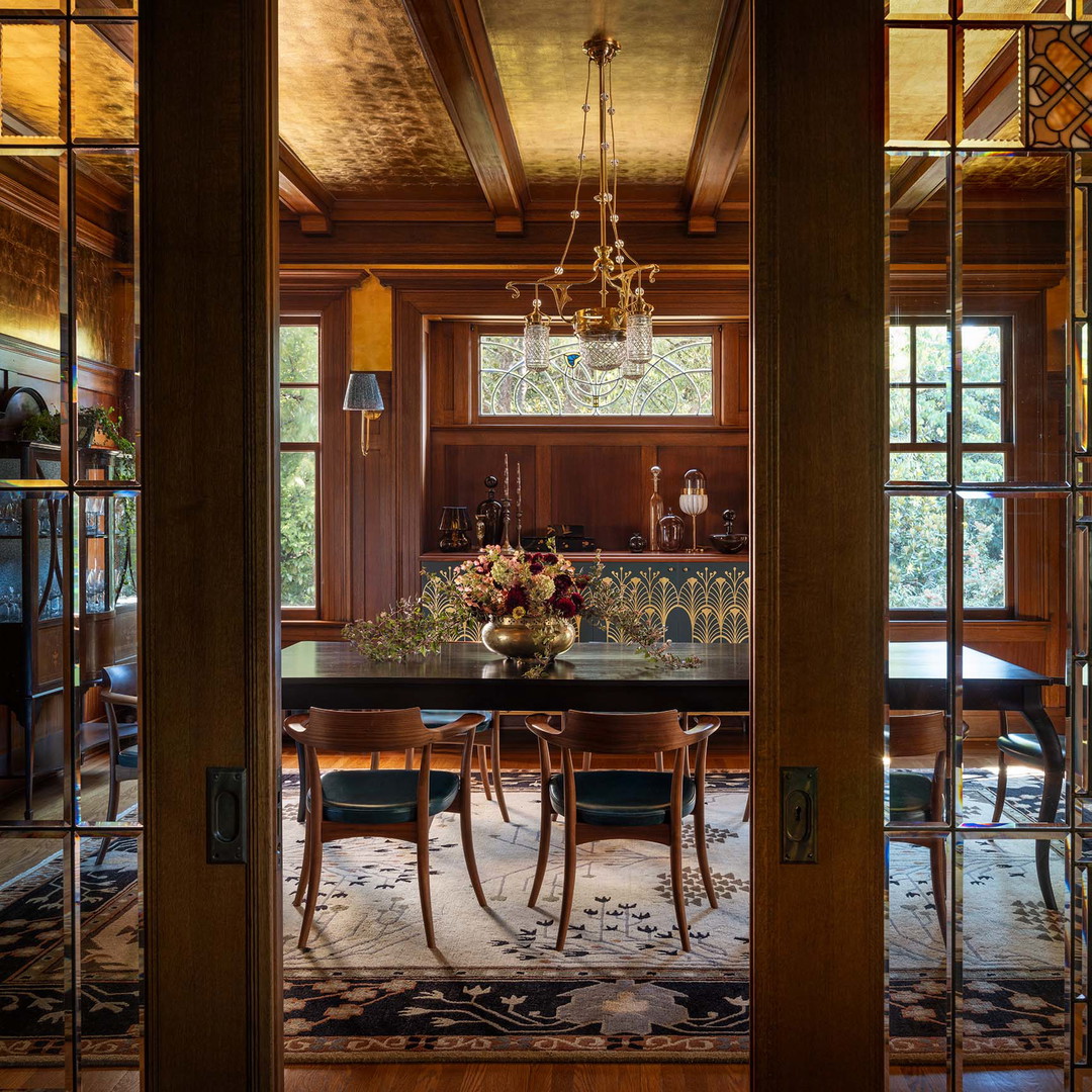 a dining room with a chandelier hanging from the ceiling