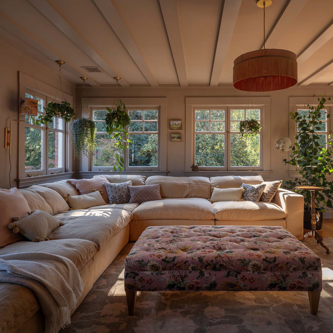 a living room filled with furniture and a large window