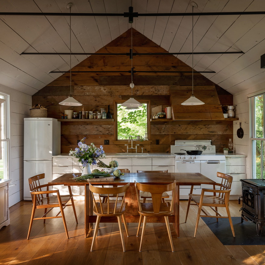 a kitchen with a table and chairs in it