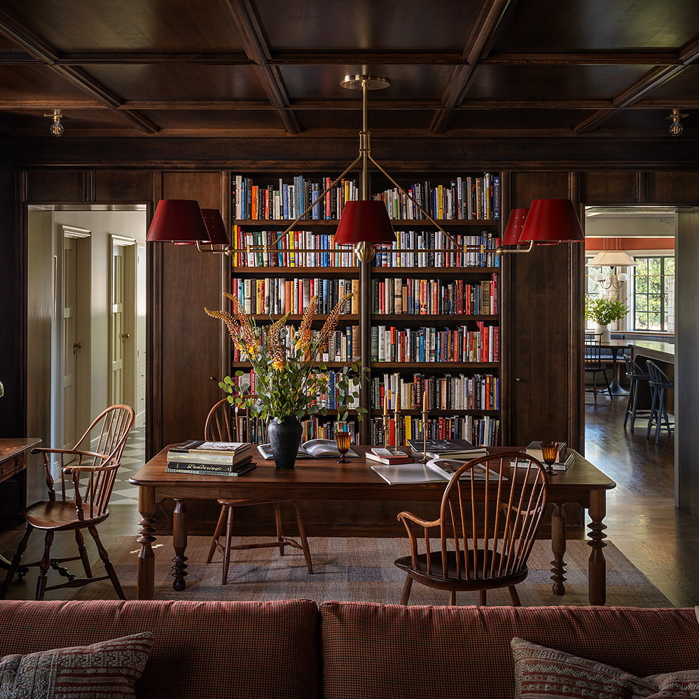 a living room filled with furniture and a book shelf