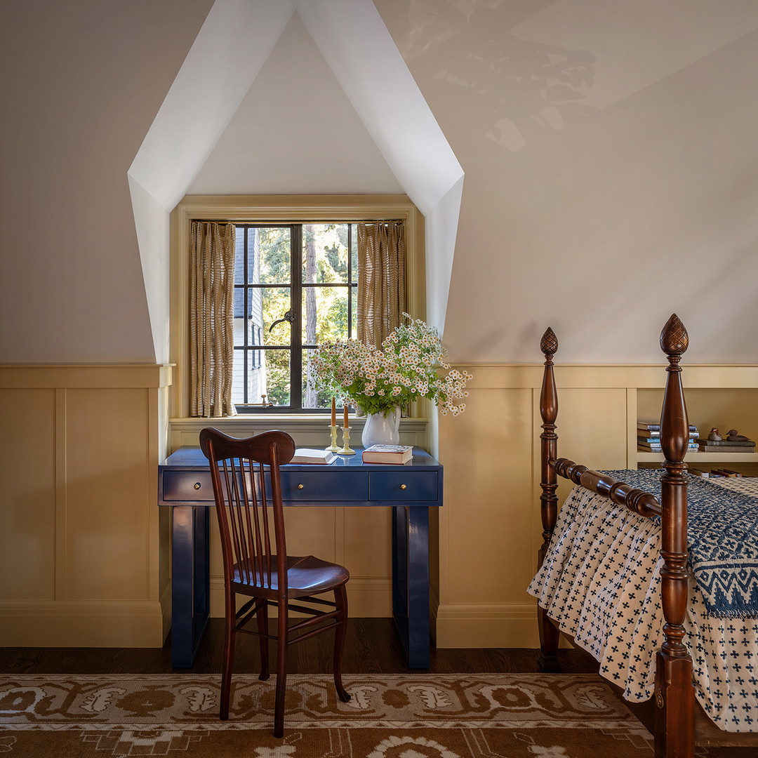 a bedroom with a bed, desk and chair