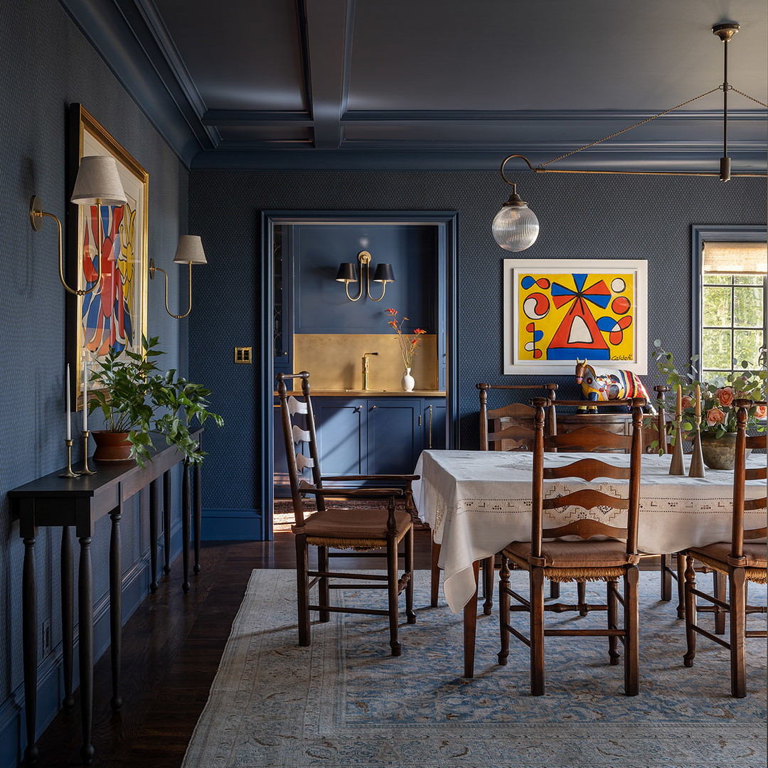 a dining room with a table and chairs